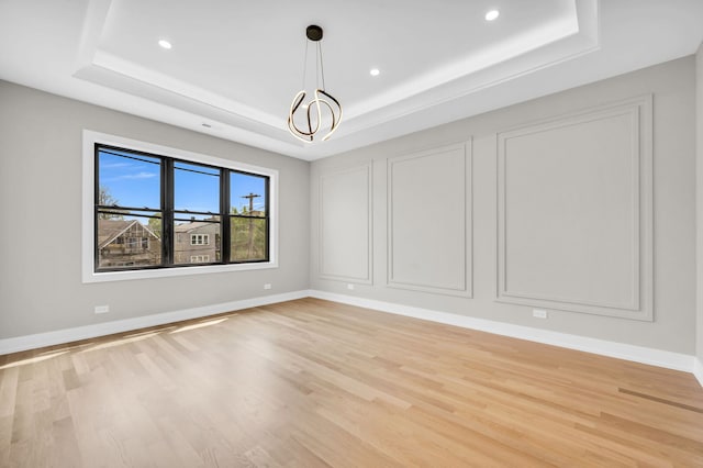 3903 N Drake Ave, Chicago, IL 60618 - unfurnished room with a tray ceiling, recessed lighting, light wood-style flooring, baseboards, and a chandelier