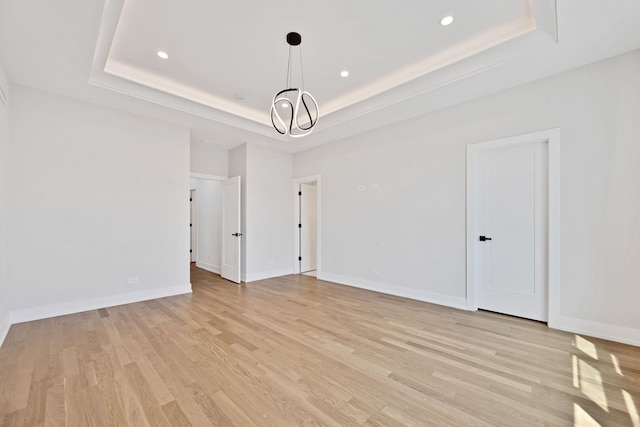 3903 N Drake Ave, Chicago, IL 60618 - spare room with a tray ceiling, light wood-style flooring, recessed lighting, a chandelier, and baseboards