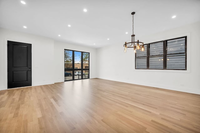 3903 N Drake Ave, Chicago, IL 60618 - spare room with a chandelier, light wood finished floors, recessed lighting, and baseboards