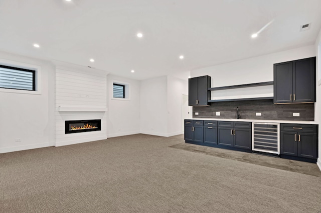 3903 N Drake Ave, Chicago, IL 60618 - bar featuring wine cooler, decorative backsplash, a fireplace, baseboards, and light carpet