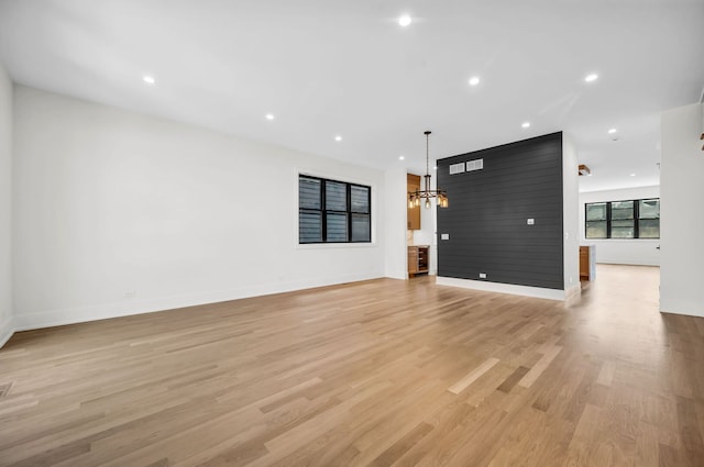 3903 N Drake Ave, Chicago, IL 60618 - unfurnished living room with a chandelier, baseboards, light wood finished floors, and recessed lighting