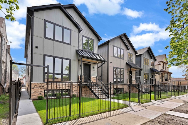 3903 N Drake Ave, Chicago, IL 60618 - view of front of property featuring a gate, a standing seam roof, board and batten siding, and brick siding