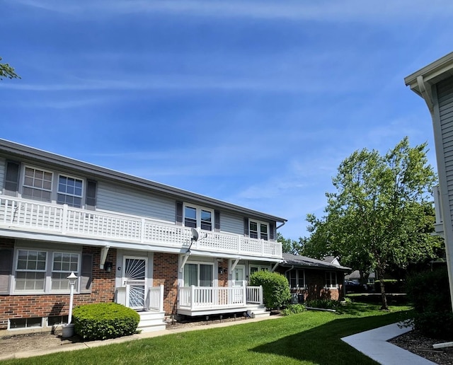 306 Milton Ct Unit B, Bloomingdale, IL 60108 - view of front of property featuring a front yard, brick siding, and a balcony