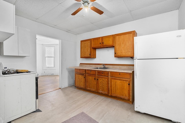2022 S Halsted St, Chicago Heights, IL 60411 - kitchen with white appliances, a sink, brown cabinetry, a drop ceiling, and light countertops
