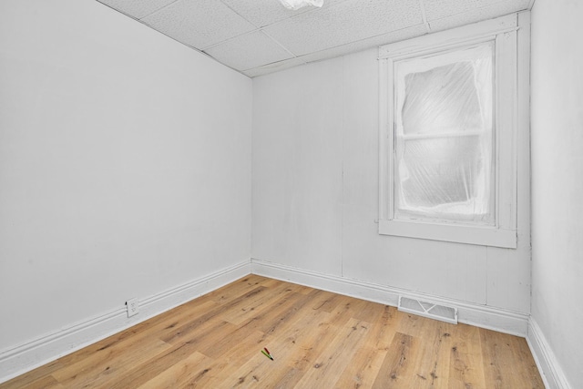 2022 S Halsted St, Chicago Heights, IL 60411 - unfurnished room featuring baseboards, light wood-style flooring, and a drop ceiling
