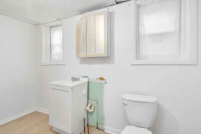 2022 S Halsted St, Chicago Heights, IL 60411 - bathroom featuring vanity, toilet, a drop ceiling, baseboards, and wood finished floors