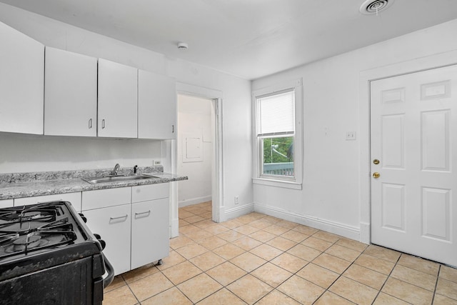 2022 S Halsted St, Chicago Heights, IL 60411 - kitchen featuring black gas range, light countertops, a sink, and white cabinetry