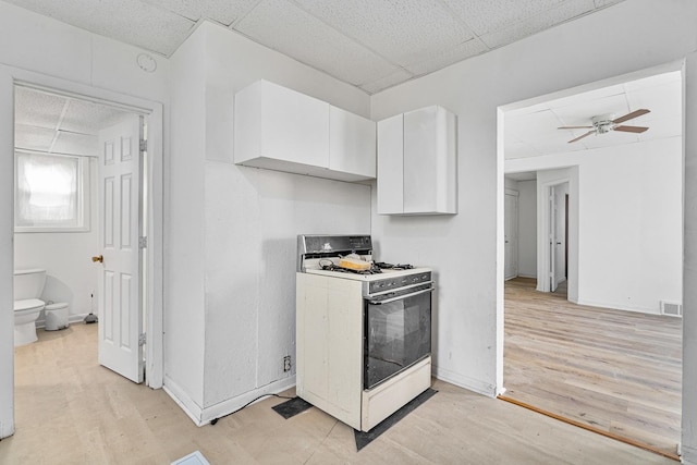 2022 S Halsted St, Chicago Heights, IL 60411 - kitchen featuring gas range gas stove, a paneled ceiling, white cabinets, light wood-style floors, and a ceiling fan
