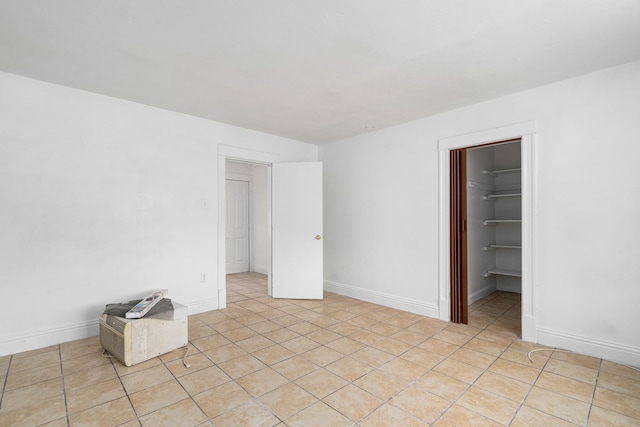 2022 S Halsted St, Chicago Heights, IL 60411 - unfurnished bedroom with a walk in closet, light tile patterned floors, and baseboards