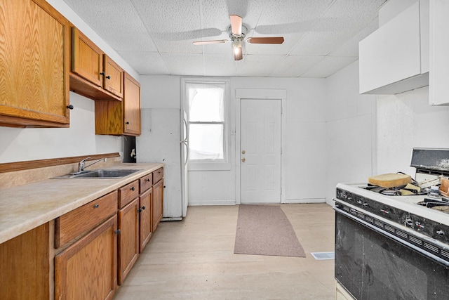 2022 S Halsted St, Chicago Heights, IL 60411 - kitchen with white appliances, a sink, brown cabinets, a ceiling fan, and light countertops