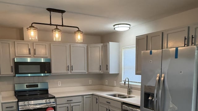1117 Cutter Ave, Joliet, IL 60432 - kitchen with appliances with stainless steel finishes, a sink, light countertops, and gray cabinetry