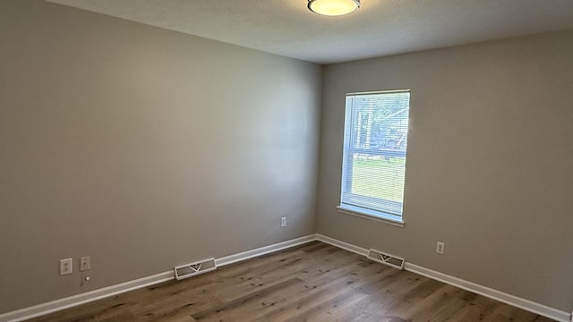 1117 Cutter Ave, Joliet, IL 60432 - unfurnished room with wood finished floors, plenty of natural light, and baseboards