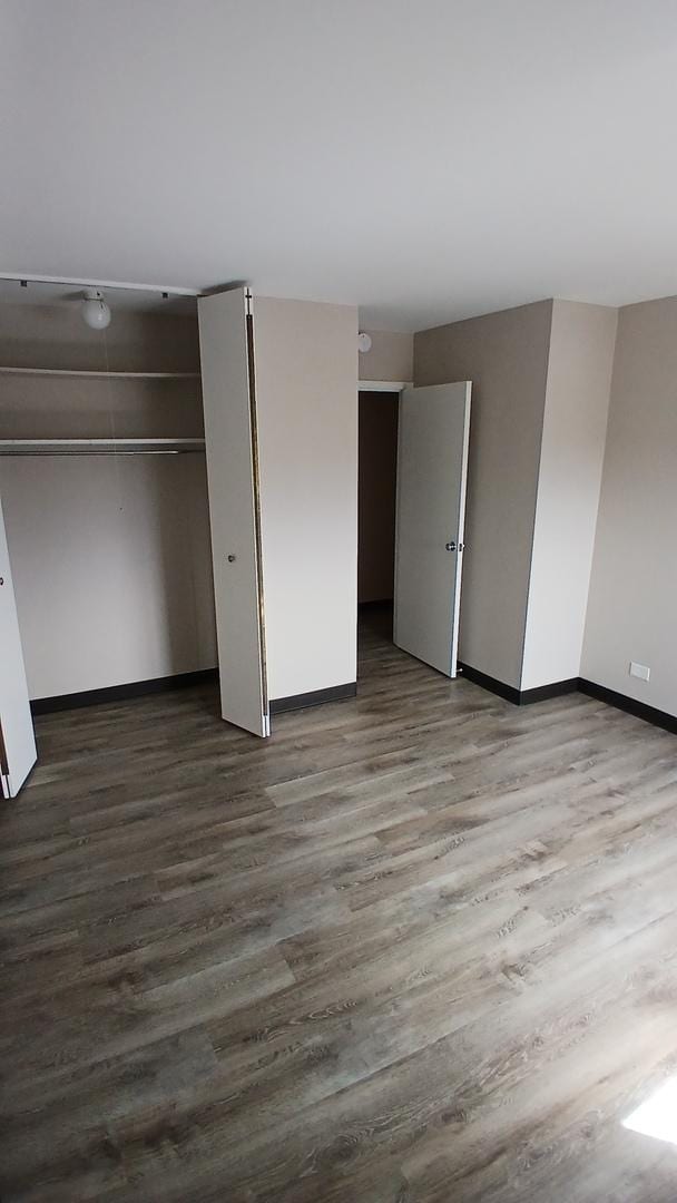 4850 S Lake Park Ave Unit 1409, Chicago, IL 60615 - unfurnished bedroom featuring wood finished floors and baseboards
