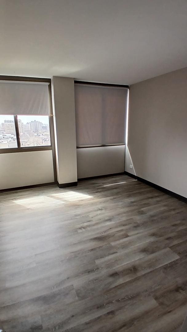 4850 S Lake Park Ave Unit 1409, Chicago, IL 60615 - unfurnished bedroom with wood finished floors and baseboards