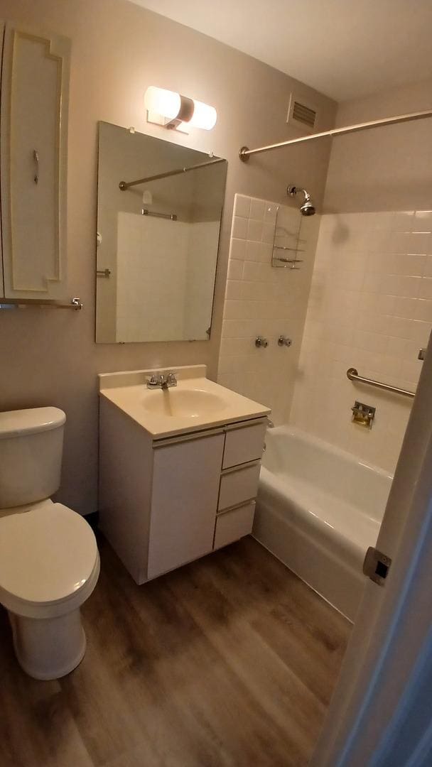 4850 S Lake Park Ave Unit 1409, Chicago, IL 60615 - full bathroom with wood finished floors, shower / washtub combination, toilet, and vanity