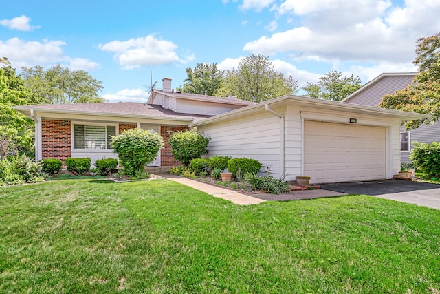 3795 Whispering Trails Dr, Hoffman Estates, IL 60192 - view of front of house with a garage, asphalt driveway, a front yard, and a chimney