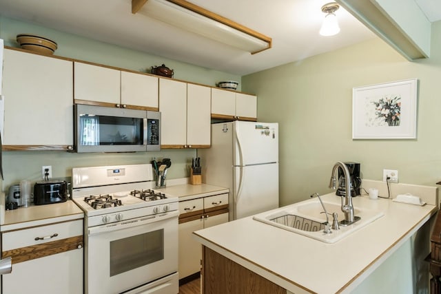 903 Wiltshire Dr Unit S2, Mchenry, IL 60050 - kitchen featuring white appliances, a sink, a peninsula, and light countertops
