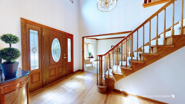 1420 Greenlake Dr, Aurora, IL 60502 - foyer with wood finished floors, stairs, a towering ceiling, and a chandelier