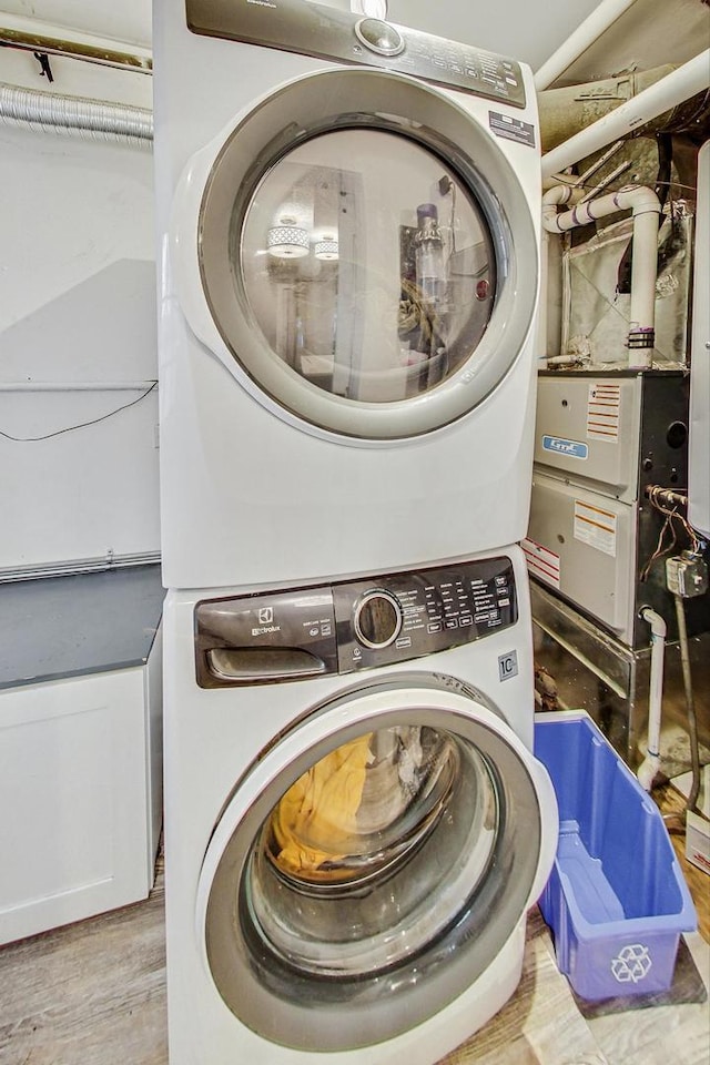1049 Fowler Ave, Evanston, IL 60202 - laundry room with stacked washer / dryer and wood finished floors