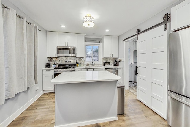 1049 Fowler Ave, Evanston, IL 60202 - kitchen with appliances with stainless steel finishes, a sink, light wood-style floors, backsplash, and recessed lighting