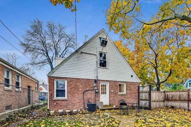 1049 Fowler Ave, Evanston, IL 60202 - back of house with brick siding and a patio