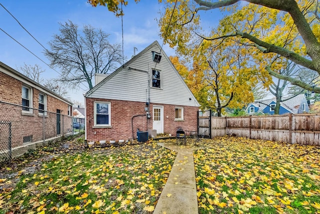 1049 Fowler Ave, Evanston, IL 60202 - rear view of property with brick siding and a fenced backyard