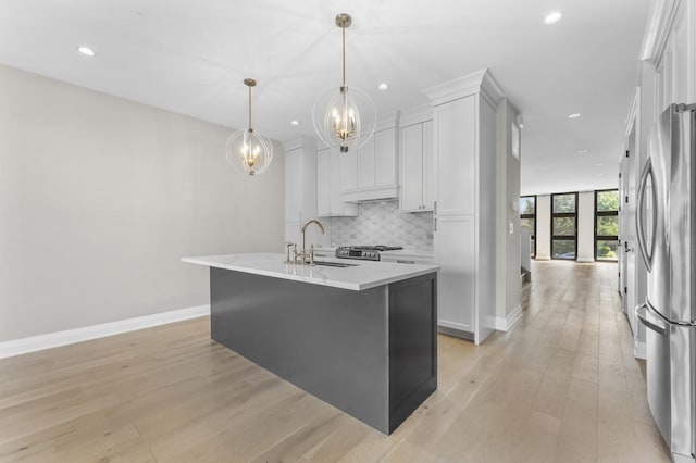 3406 N Keating Ave, Chicago, IL 60641 - kitchen with a chandelier, appliances with stainless steel finishes, tasteful backsplash, white cabinetry, and light wood-style flooring