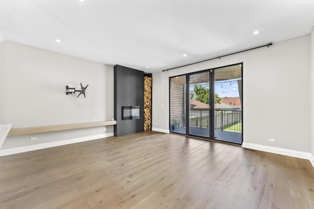 3406 N Keating Ave, Chicago, IL 60641 - unfurnished living room with wood finished floors and recessed lighting