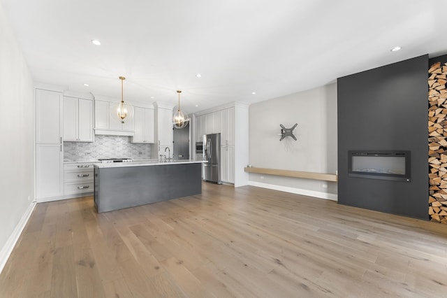 3406 N Keating Ave, Chicago, IL 60641 - kitchen featuring stainless steel fridge, recessed lighting, white cabinets, light countertops, and a chandelier