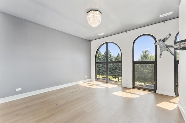 3406 N Keating Ave, Chicago, IL 60641 - empty room with wood finished floors and a chandelier