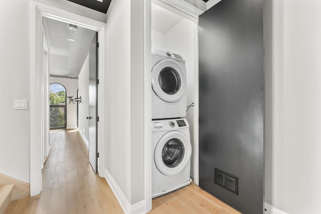 3406 N Keating Ave, Chicago, IL 60641 - washroom featuring stacked washing machine and dryer and light wood-type flooring