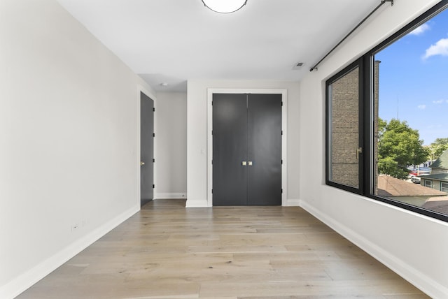 3406 N Keating Ave, Chicago, IL 60641 - unfurnished bedroom with light wood-style flooring and a closet