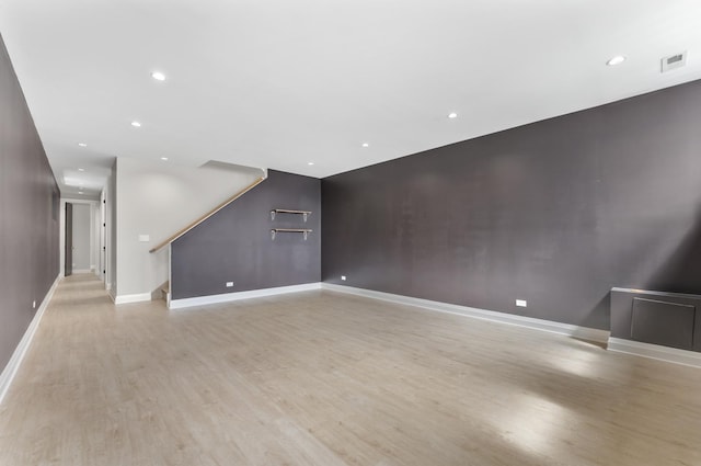 3406 N Keating Ave, Chicago, IL 60641 - unfurnished living room with light wood-style flooring, stairway, and recessed lighting