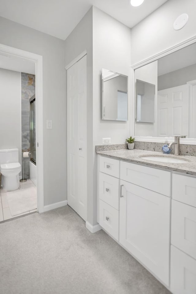 886 Ann Arbor Ln, Vernon Hills, IL 60061 - bathroom with vanity, toilet, enclosed tub / shower combo, and baseboards
