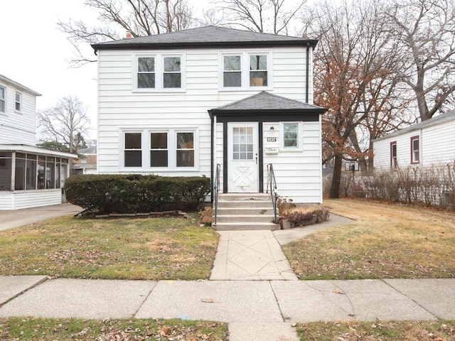 9237 S Utica Ave, Evergreen Park, IL 60805 - american foursquare style home with a sunroom, entry steps, roof with shingles, and a front lawn