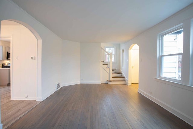 9237 S Utica Ave, Evergreen Park, IL 60805 - spare room with wood finished floors, baseboards, arched walkways, and stairs