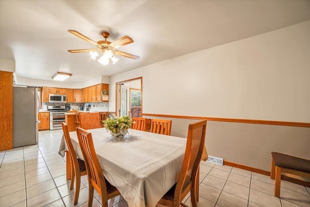 16308 S Peerless Ct, Plainfield, IL 60586 - dining area featuring a ceiling fan, light tile patterned floors, and baseboards