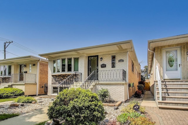 5560 W Ardmore Ave, Chicago, IL 60646 - view of front of house featuring brick siding, stairs, and covered porch