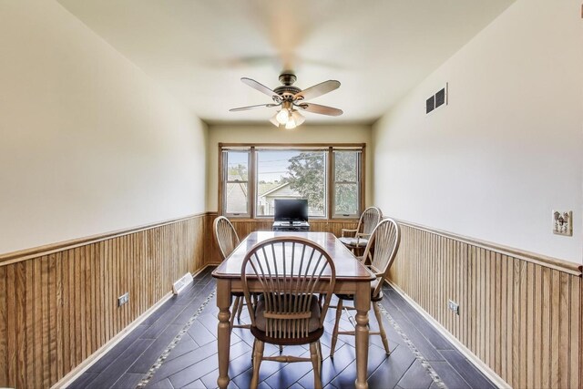 5560 W Ardmore Ave, Chicago, IL 60646 - dining area with a wainscoted wall, a ceiling fan, and wooden walls