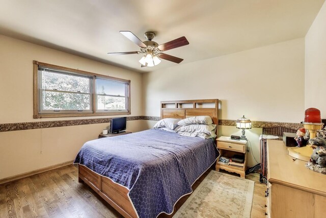 5560 W Ardmore Ave, Chicago, IL 60646 - bedroom with wood finished floors, baseboards, and ceiling fan
