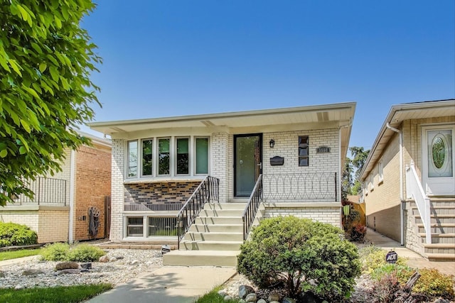 5560 W Ardmore Ave, Chicago, IL 60646 - view of front of property featuring stairs, covered porch, and brick siding