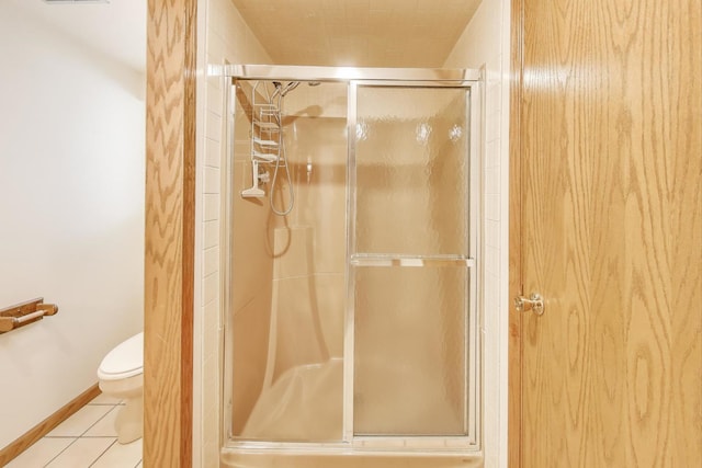 5560 W Ardmore Ave, Chicago, IL 60646 - full bathroom with a stall shower, toilet, and tile patterned floors