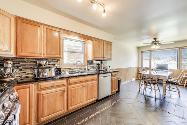 5560 W Ardmore Ave, Chicago, IL 60646 - kitchen with stainless steel dishwasher, a sink, range, a wainscoted wall, and ceiling fan