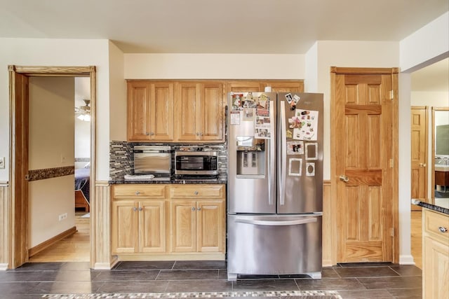 5560 W Ardmore Ave, Chicago, IL 60646 - kitchen featuring stainless steel appliances, backsplash, dark stone counters, and ceiling fan