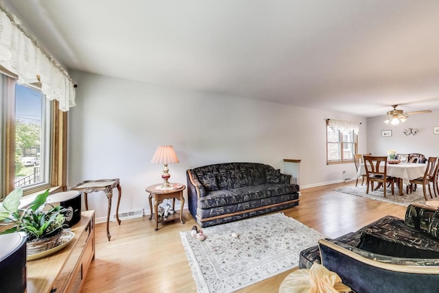 5560 W Ardmore Ave, Chicago, IL 60646 - living room featuring a ceiling fan, light wood finished floors, and baseboards