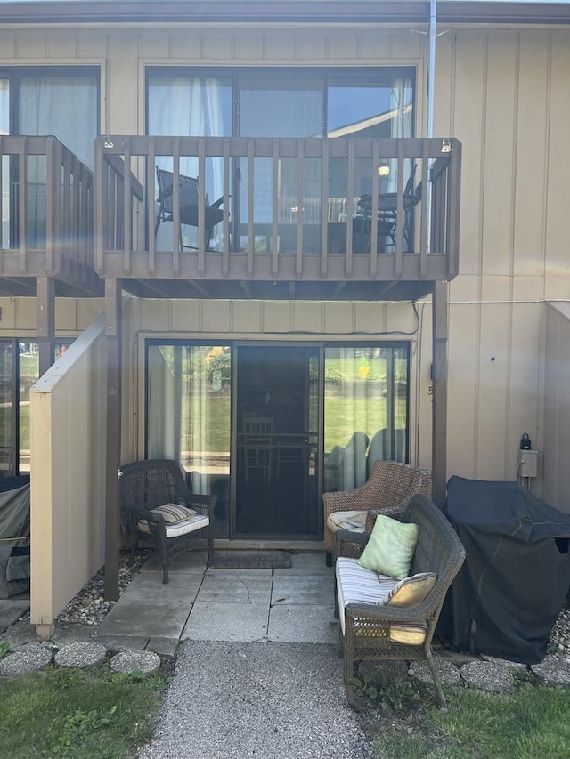 57 Vail Colony Unit 7, Fox Lake, IL 60020 - property entrance with board and batten siding, a balcony, and a patio