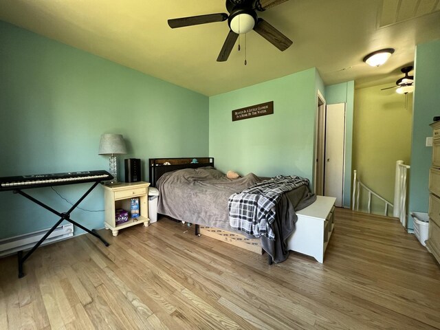 57 Vail Colony Unit 7, Fox Lake, IL 60020 - bedroom with wood finished floors, ceiling fan, and a baseboard heating unit