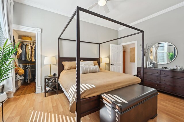 2149 N Seminary Ave Unit A, Chicago, IL 60614 - bedroom with ornamental molding, a spacious closet, light wood-type flooring, a closet, and a ceiling fan
