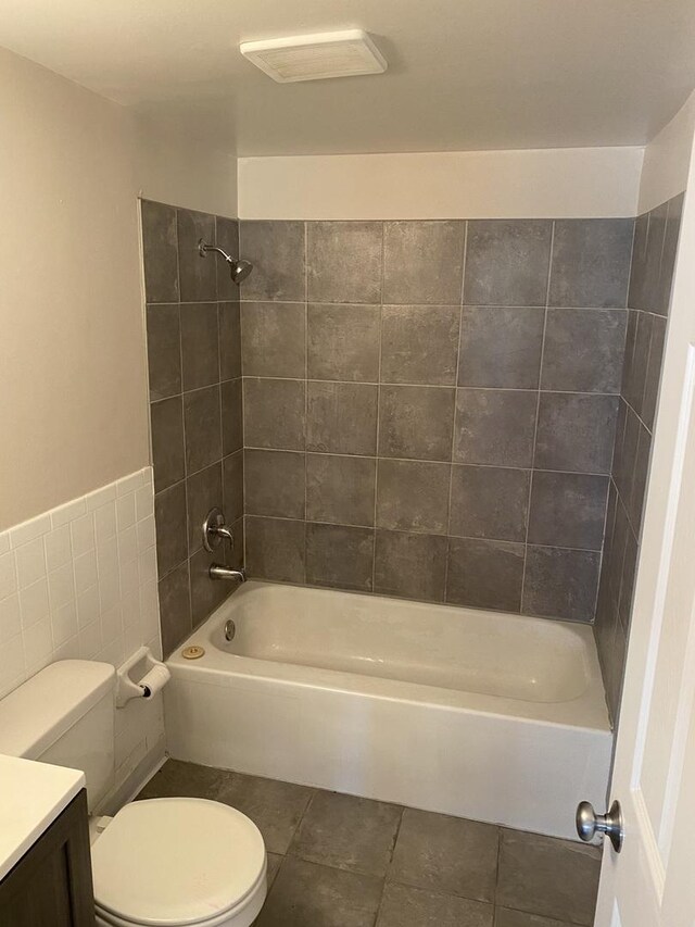 265 E Prairie St, Manhattan, IL 60442 - bathroom featuring toilet, vanity, washtub / shower combination, tile patterned floors, and tile walls