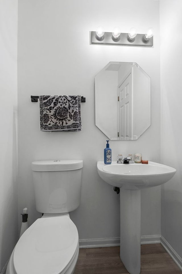 1585 Belle Haven Dr, Grayslake, IL 60030 - half bathroom with baseboards, wood finished floors, toilet, and a sink